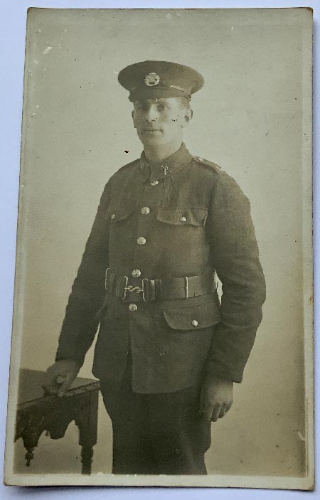 WWI soldier postcard wearing collar Pioneer Battalions badges